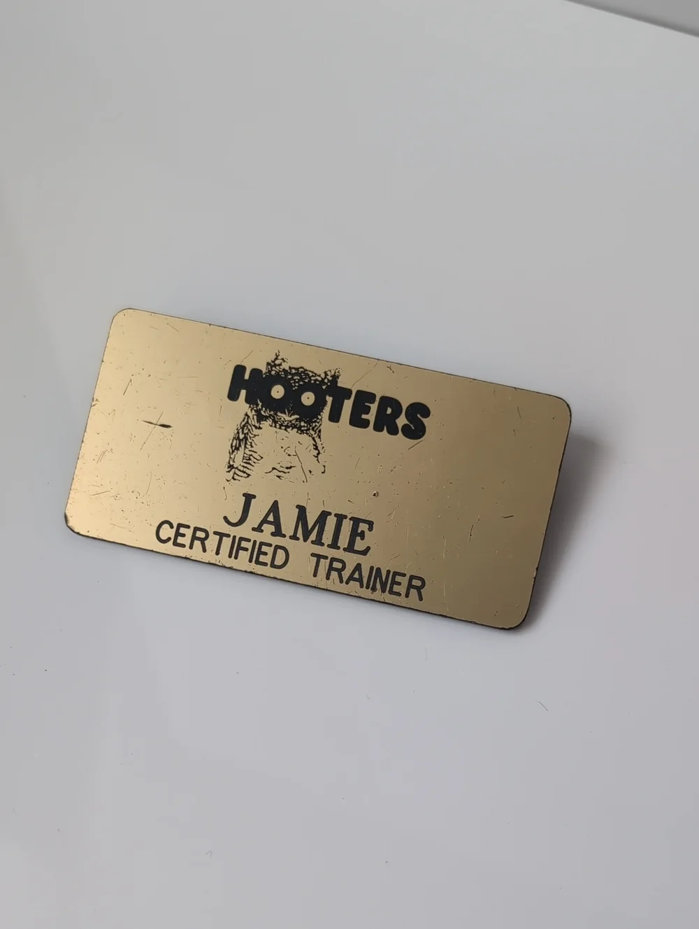 Hooters Gold Name Badge with Black Logo and Text